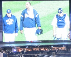 Flanked by pitching coach Larry Rothschild and catcher Russell Martin, CC Sabathia makes his way from the bullpen to the dugout just before the game.