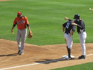 Gardner confers with Rob Thomson after his three-run second-inning triple. Brett's daredevil head-first slides into bases are a concern, particularly following on his injury-plagued 2012 season.