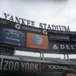 It's early Saturday, and our sneakers have just hit the warning track dirt, with welcoming signage behind us indicating Yankee Stadium "Photo Day."